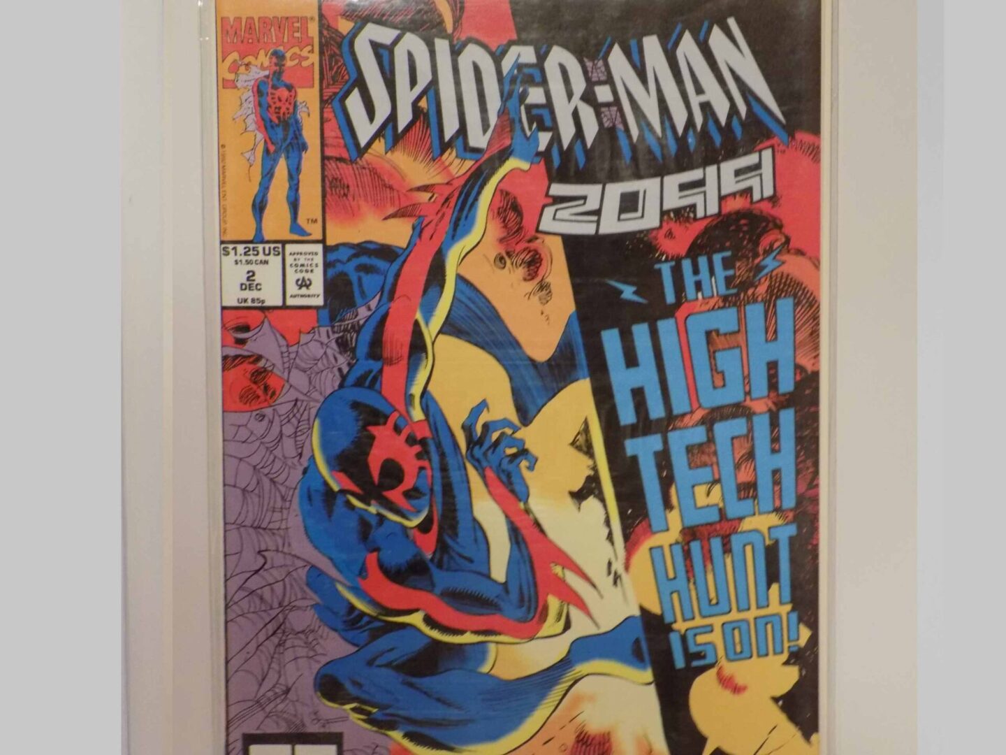 A spider-man comic book in a display case.