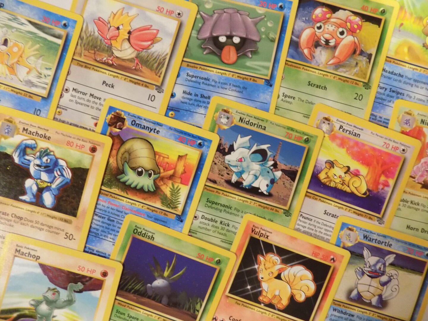 A pile of pokemon cards on a table.