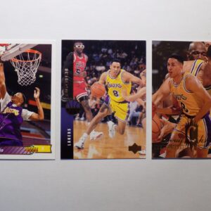 Three Christie, Doug basketball cards with a basketball player in the middle.