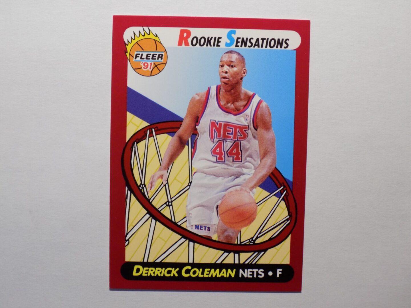 A Derrick Coleman card with a basketball in it.