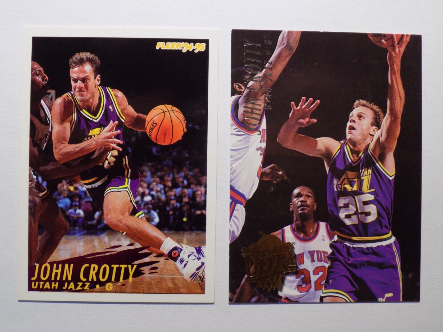 A pair of basketball cards with a picture of John Crotty.