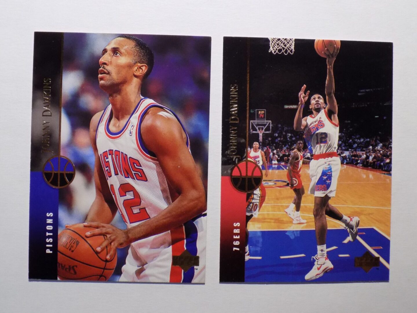 A pair of Dawkins, Johnny basketball cards with two players on them.