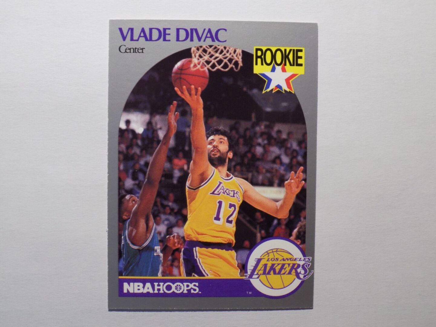 A basketball card with a picture of Divac, Vlade, a Lakers player.