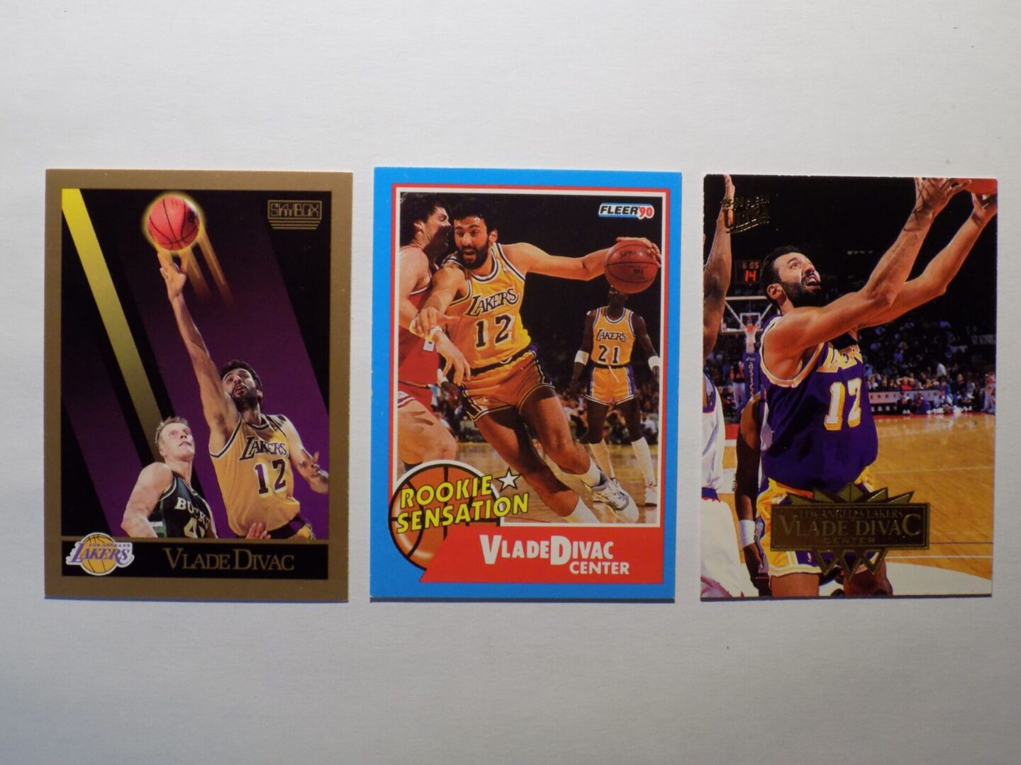 Three basketball cards with a picture of Divac, Vlade.