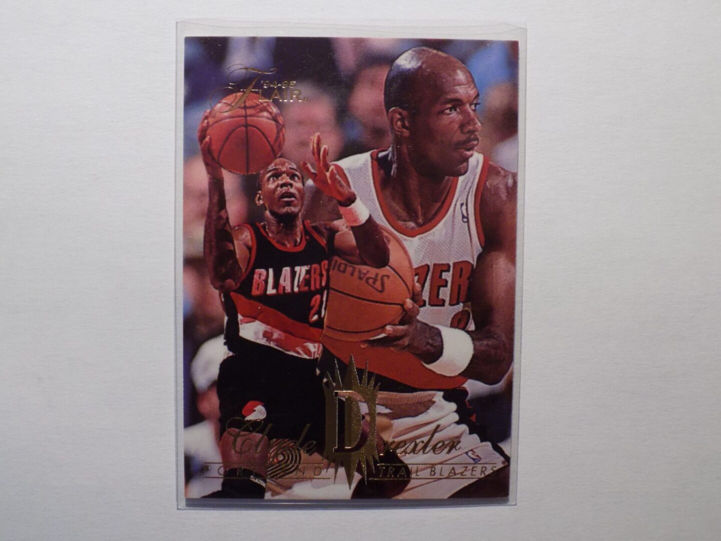 A Clyde Drexler basketball card with a picture of a player.