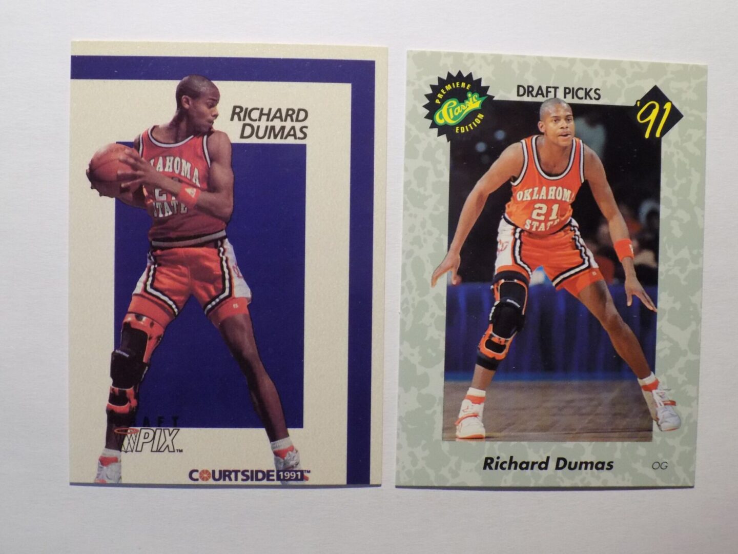 A pair of Dumas, Richard basketball cards with two players on them.