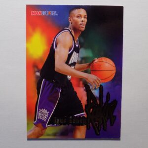 A Tyus Edney basketball card with a man holding a ball.