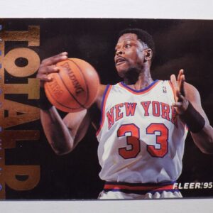 A basketball card with Patrick Ewing holding a ball.