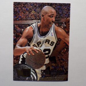 A basketball card with Sean Elliott holding a ball.