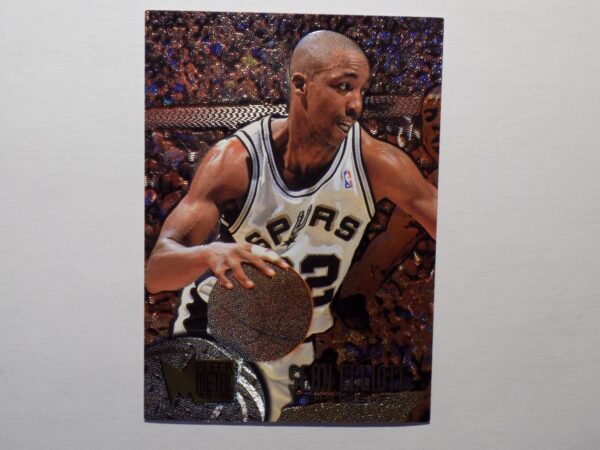 A basketball card with Sean Elliott holding a ball.