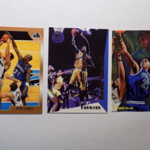 Three Garnett, Kevin basketball cards with a basketball player in the background.