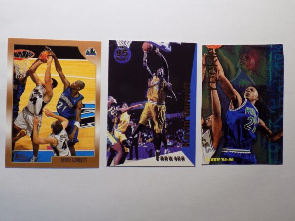 Three Garnett, Kevin basketball cards with a basketball player in the background.