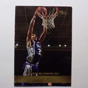 A Grant Hill basketball card with a player dunking the ball.