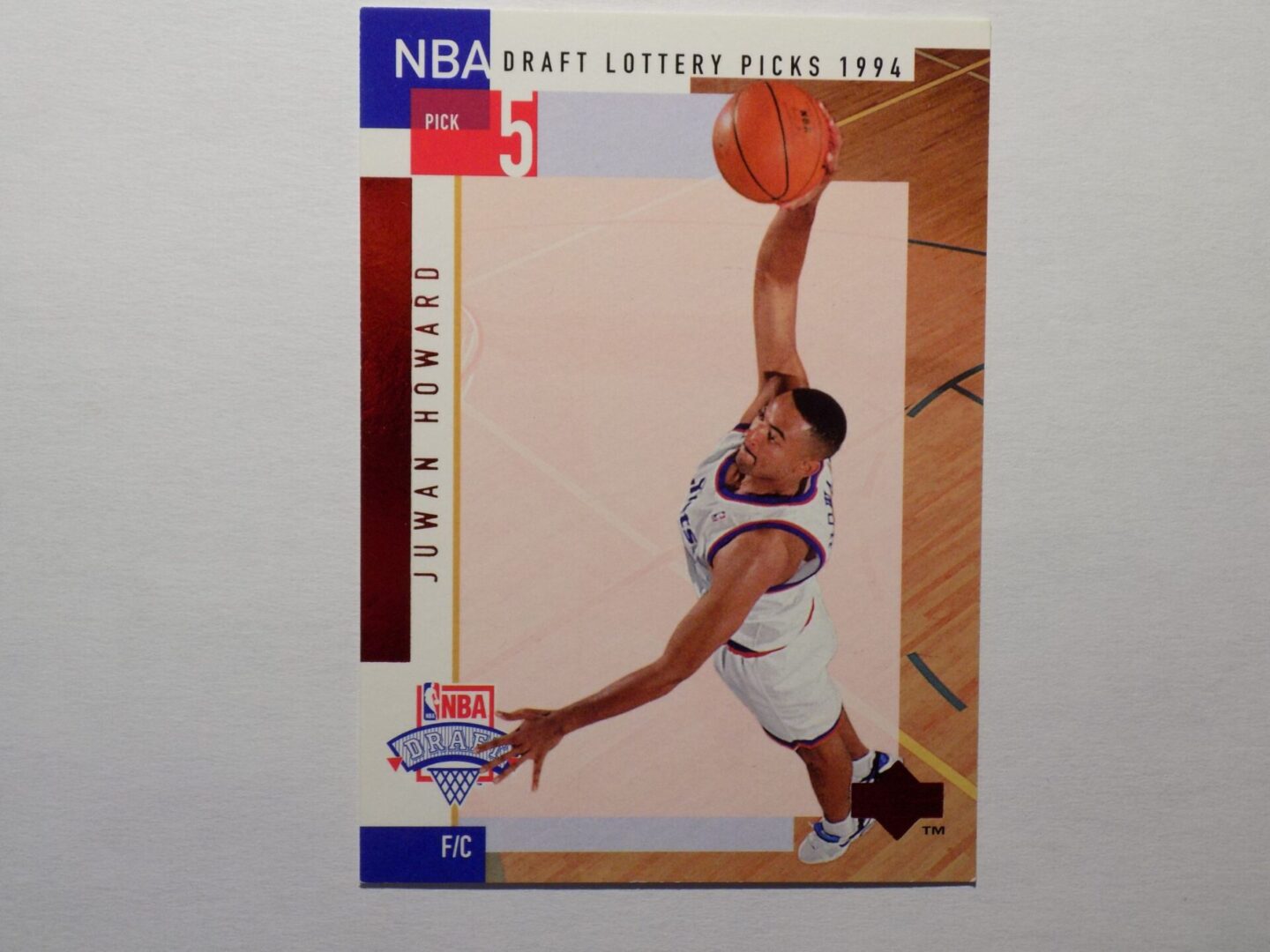 A Howard, Juwon card with an image of a man dribbling.