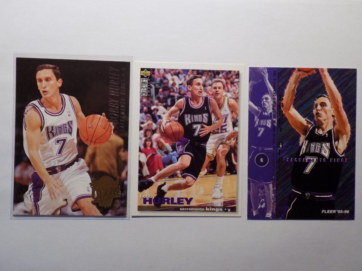 Three Hurley basketball cards with different players on them.