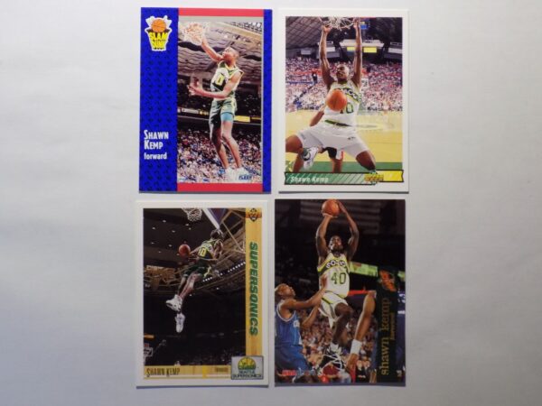 A set of Kemp, Shawn basketball cards with a player in the air.