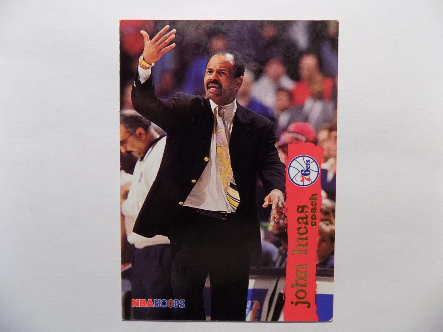 A Lucas card with a man in a suit waving.