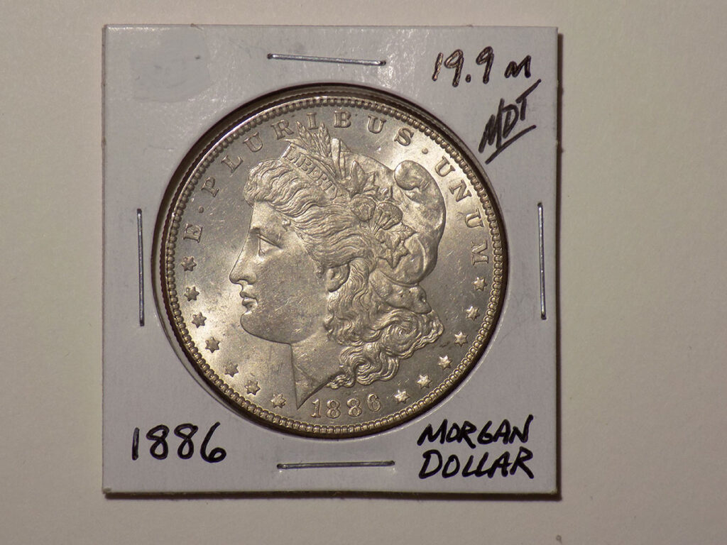 1886 Morgan silver dollar coin.