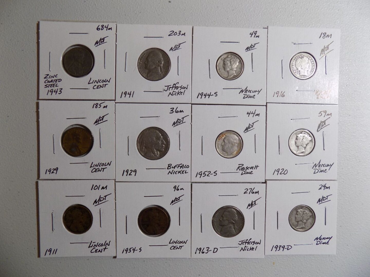 Collection of US coins in protective cases.