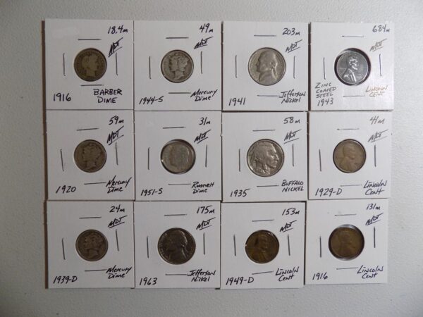 Collection of US coins on white display cards.