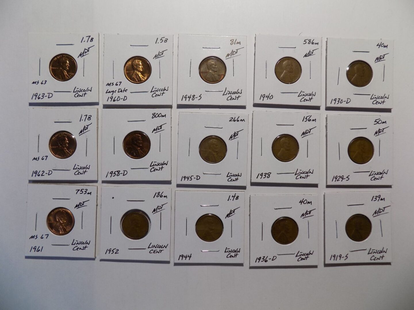 Collection of Lincoln pennies in plastic holders.