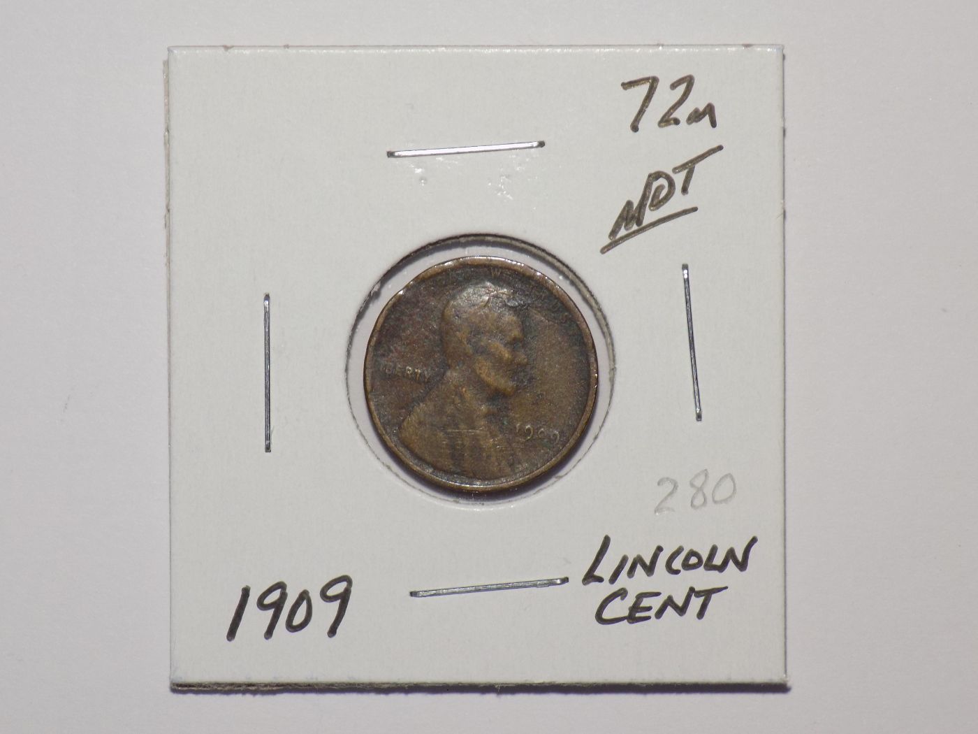 1909 Lincoln penny in a coin holder.