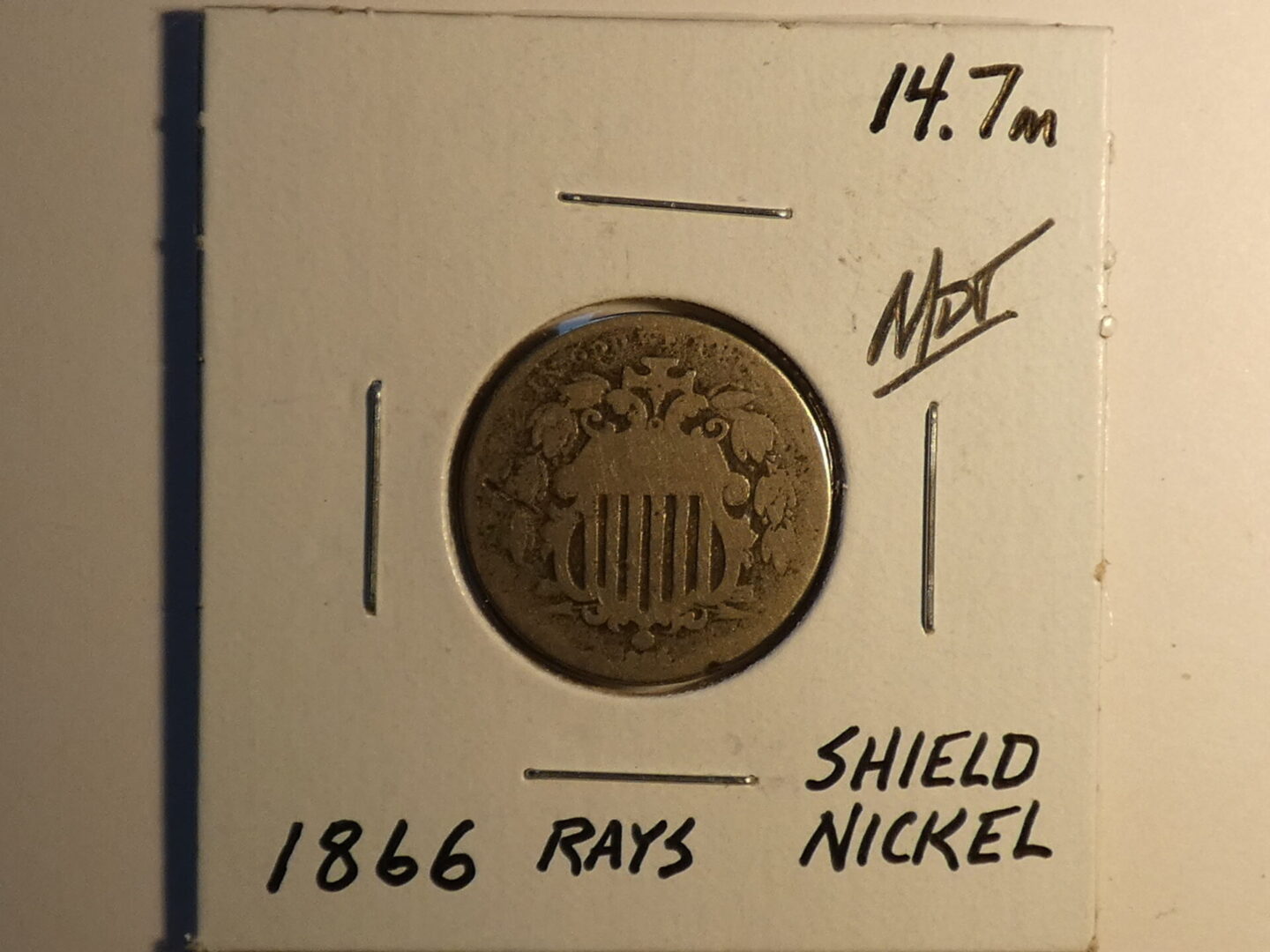 1866 Shield Nickel coin with rays.