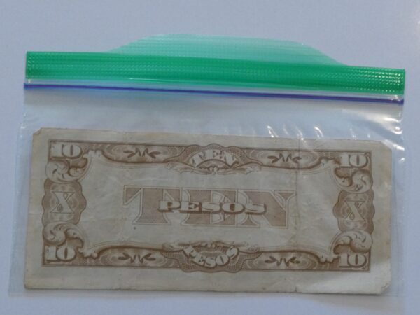 Ten Peso bill in a plastic bag.