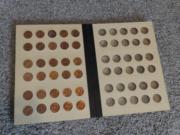 Coin collection album with empty slots.