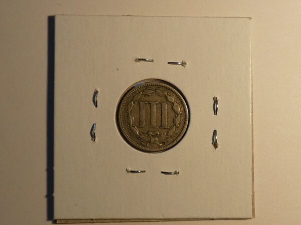 Three-cent nickel coin on display.