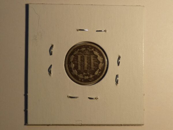 Three cent coin with laurel wreath design.