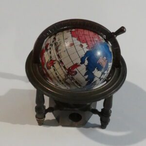 Globe shaped pencil sharpener on a stand.