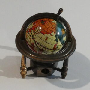 Vintage globe pencil sharpener on stand.