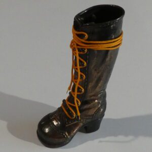 Black leather boot with yellow laces.