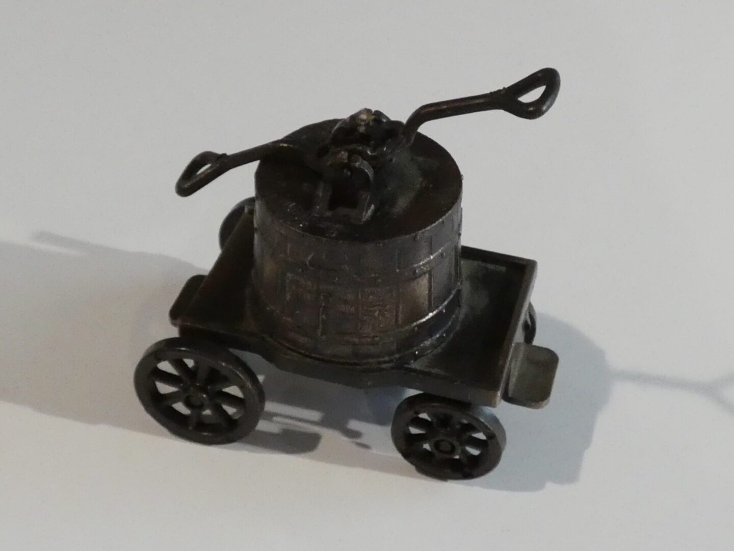 Vintage metal pencil sharpener on wheels.