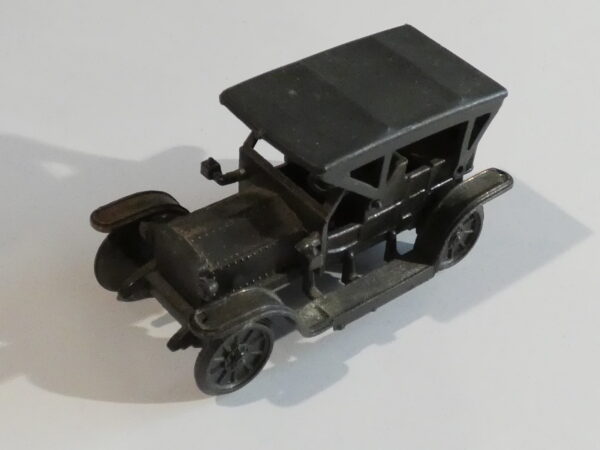 Black toy car with four wheels.