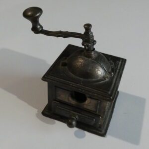 Vintage metal pencil sharpener shaped like a coffee grinder.