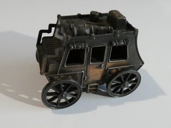 Black metal toy stagecoach with four wheels.