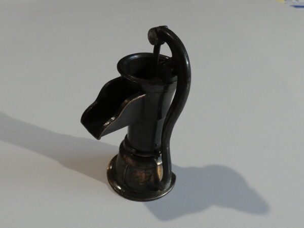 Black metal well pump pencil sharpener.