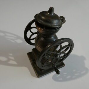 Vintage metal pencil sharpener in grinder form.