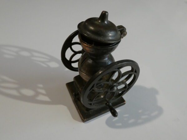 Vintage metal pencil sharpener in grinder form.