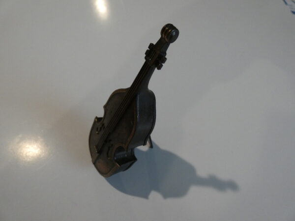 A small metal double bass figurine.