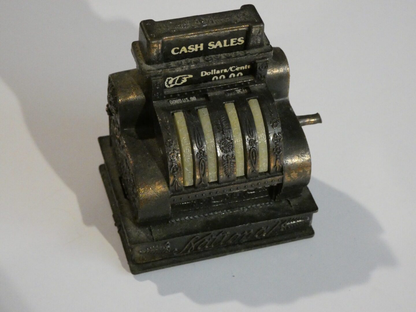 Antique black metal cash register model.