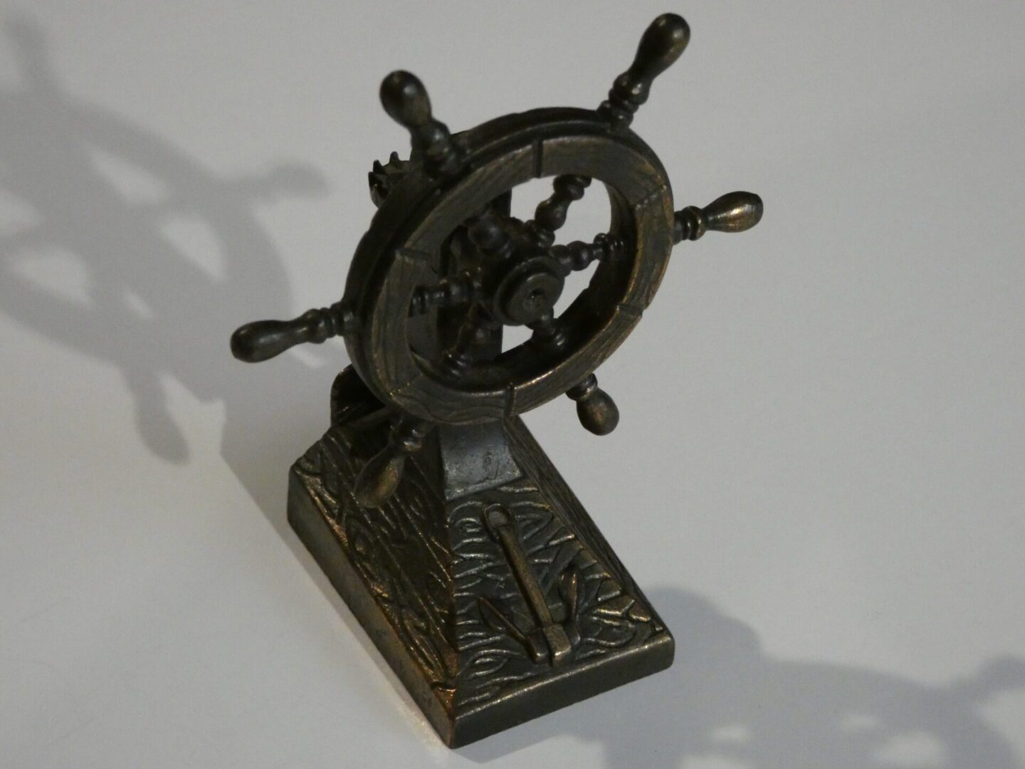 Metal ship wheel pencil sharpener.