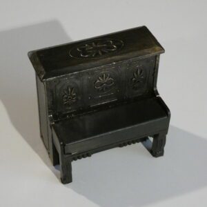 Black miniature piano with ornate details.