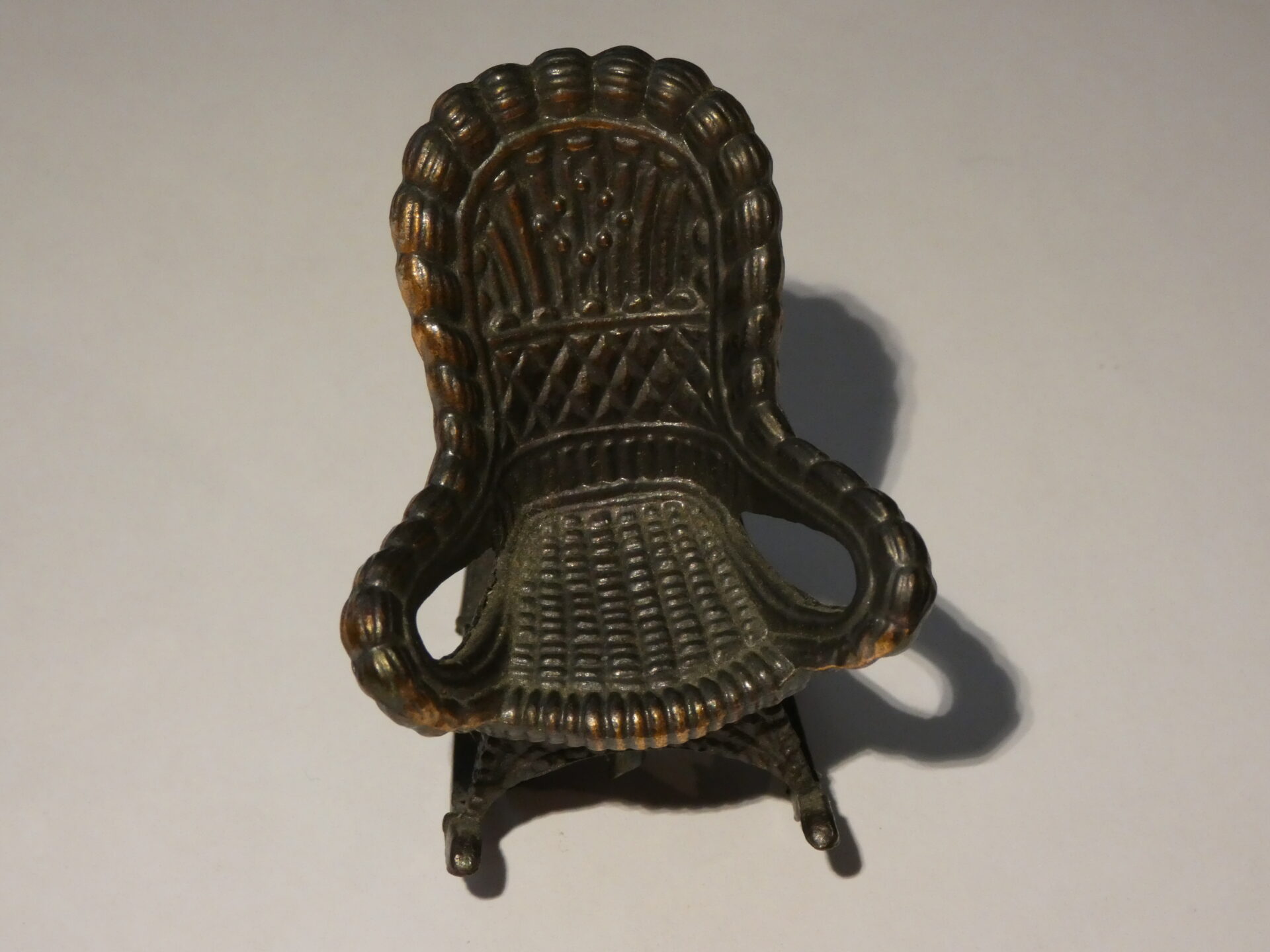 Miniature rocking chair made of metal.