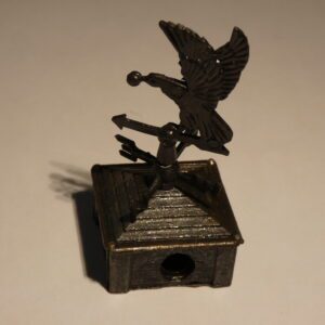 Metal pencil sharpener with bird design.