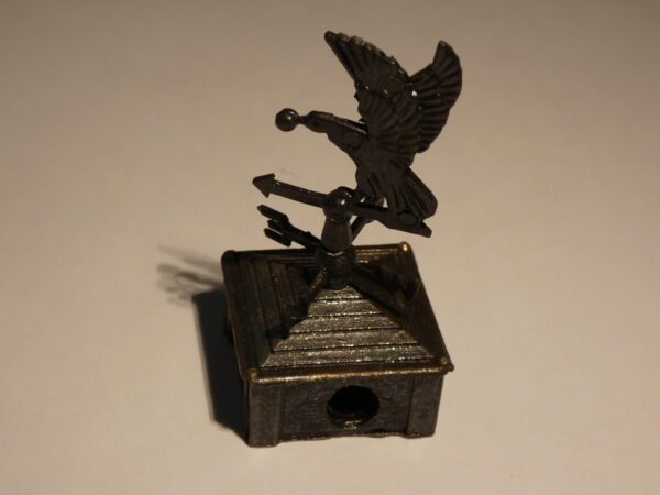 Metal pencil sharpener with bird design.