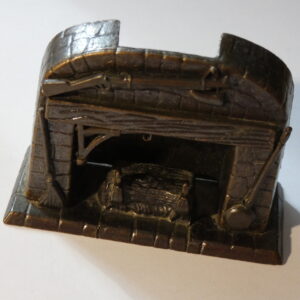 Metal figurine of a fireplace.