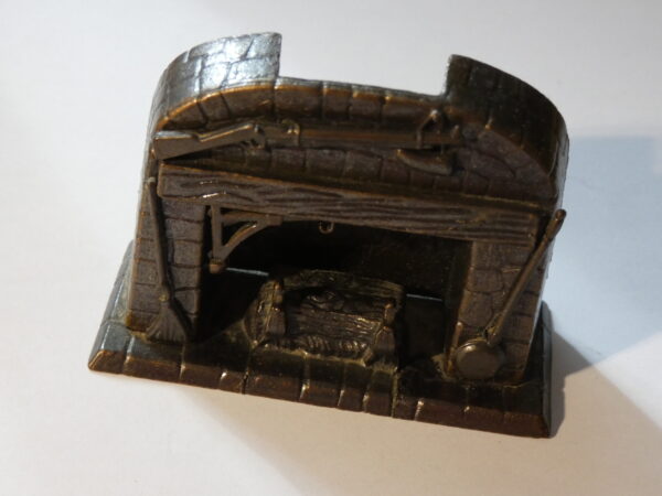 Metal figurine of a fireplace.